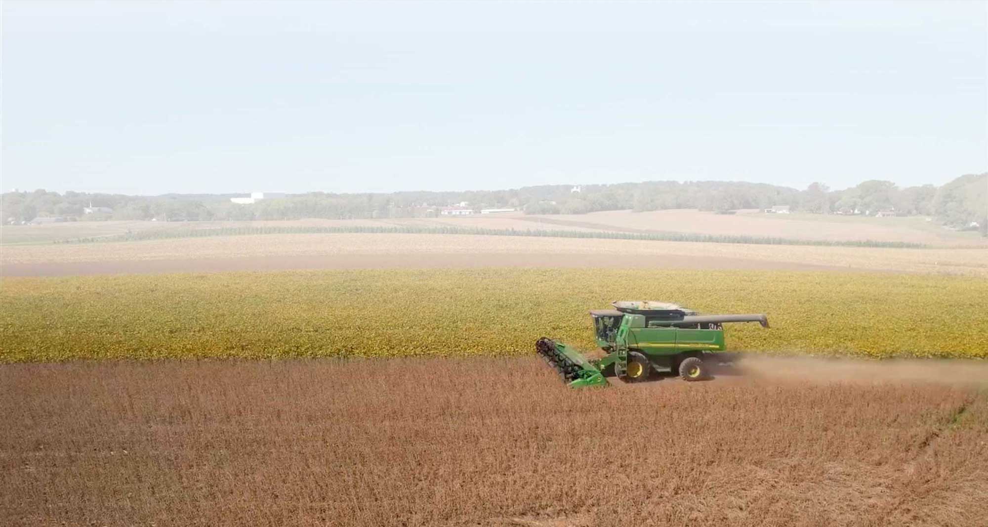 Combine driving through field